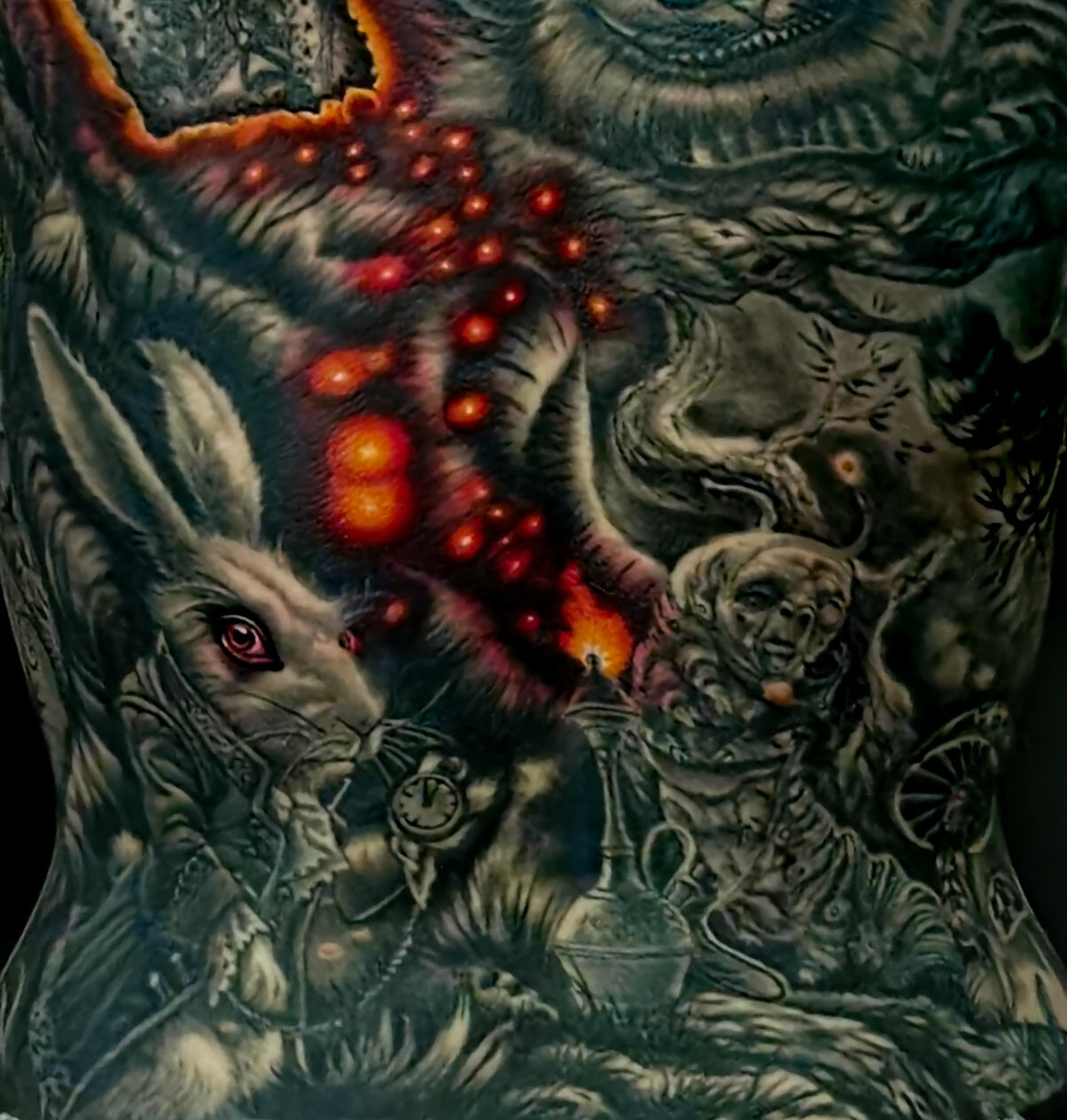 Detailed full back tattoo design of Alice in Wonderland with a rabbit, glowing eyes, and mystical elements