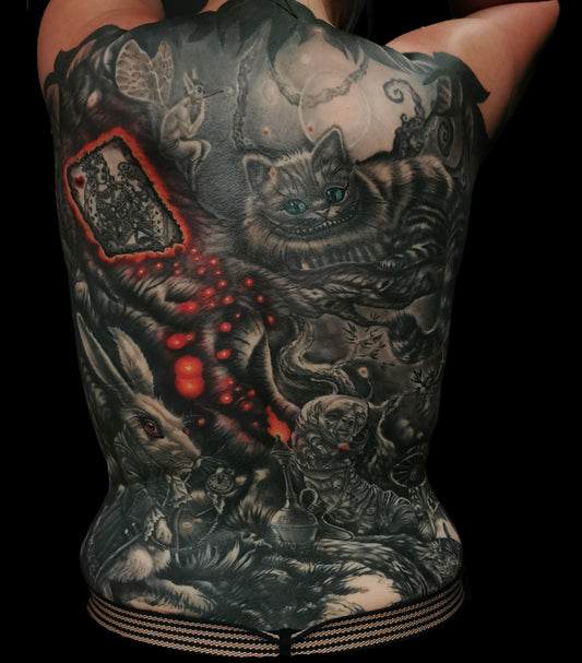 Detailed full back tattoo design of Alice in Wonderland with a rabbit, glowing eyes, and mystical elements