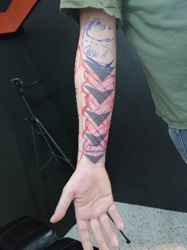 Detailed freehand cover up for metallic arm armor on a black background