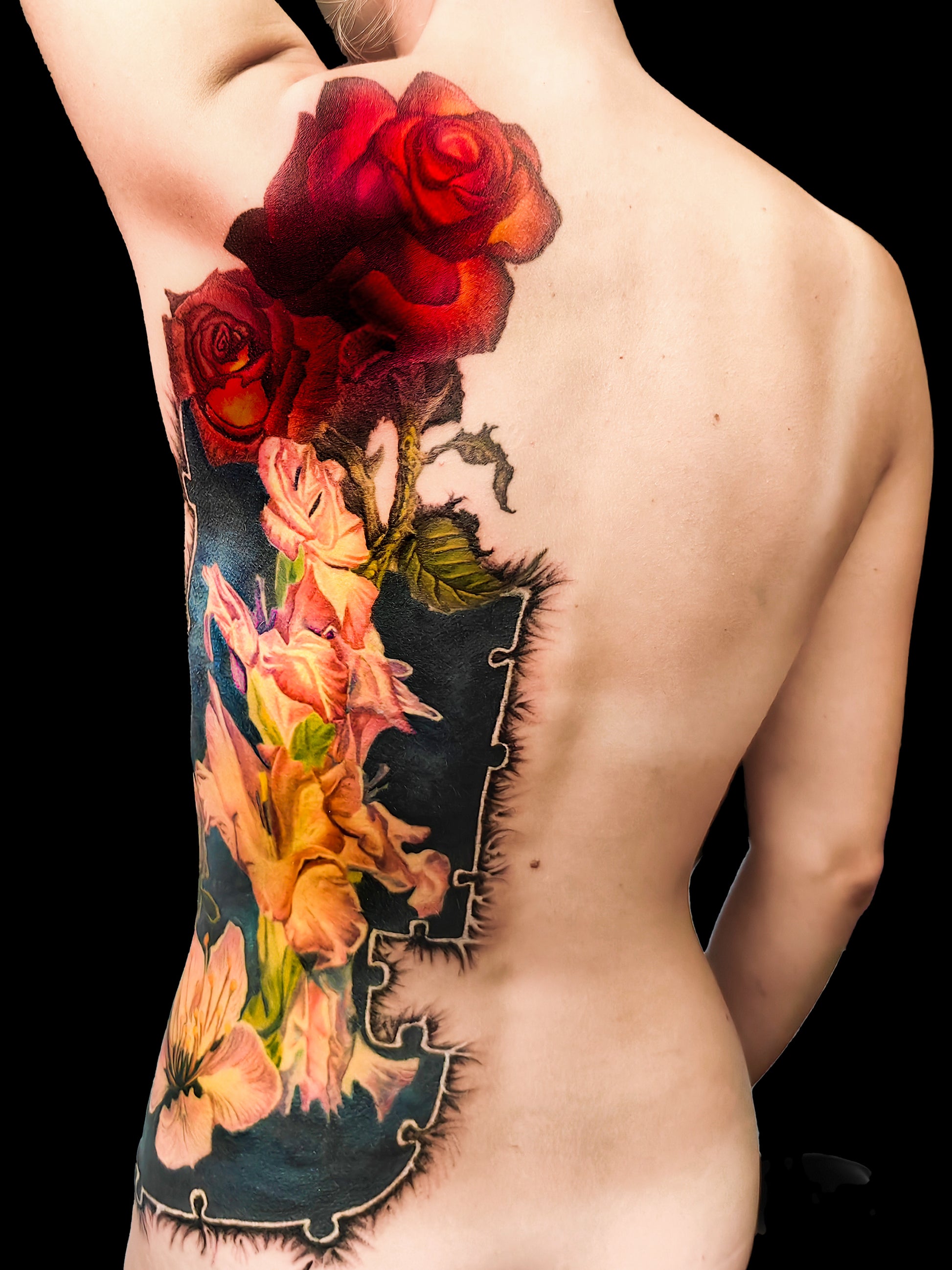 Colorful floral cover-up tattoo on the half torso with a puzzle-frame edge and a pocket watch motif