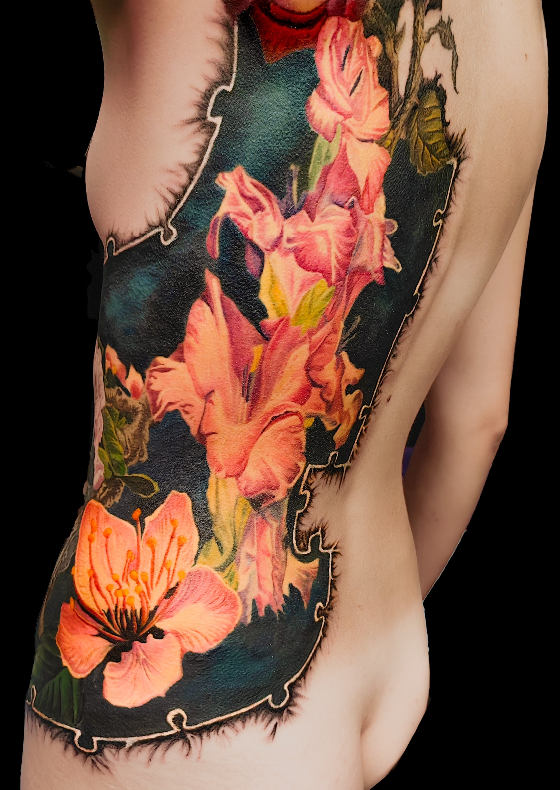 Colorful floral cover-up tattoo on the half torso with a puzzle-frame edge and a pocket watch motif