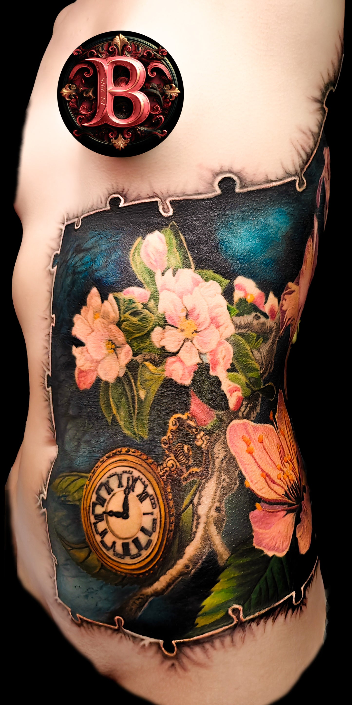 Colorful floral cover-up tattoo on the half torso with a puzzle-frame edge and a pocket watch motif